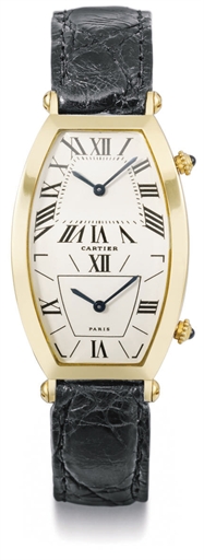 Cartier. A fine 18K gold tonneau-shaped dual time curved wristwatch