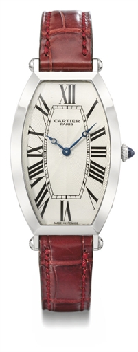 Cartier. A fine and large platinum tonneau-shaped curved wristwatch