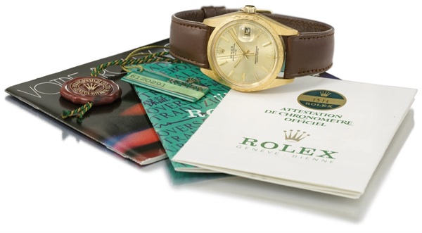 Rolex. A fine 18K gold automatic wristwatch with sweep centre seconds, date, bark-finish bezel, original guarantee, seal and box