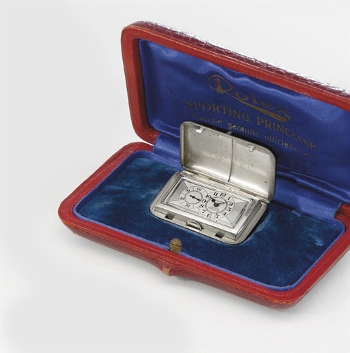 Rolex. A rare black lacquer purse watch with two-tone silvered dial and original box