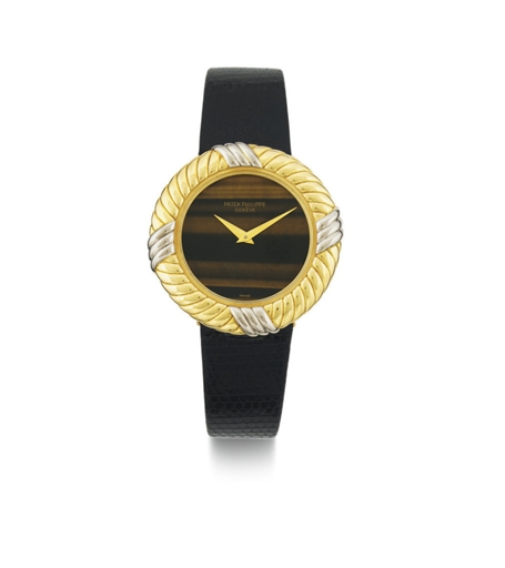 PATEK PHILIPPE. A LADY'S TWO TONE 18K GOLD AND TIGER'S EYE WRISTWATCH
