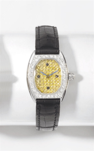 Gerald Genta. A lady's fine 18K white gold and diamond-set oval wristwatch