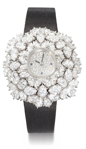 Audemars Piguet. A highly attractive and unique 18K white gold, diamond and sapphire-set flower-shaped convertible brooch and wristwatch