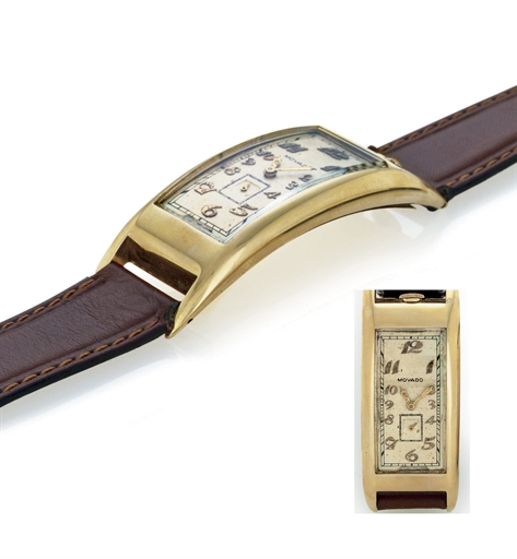 MOVADO. AN UNUSUAL OVERSIZED 14K GOLD CURVED RECTANGULAR WRISTWATCH