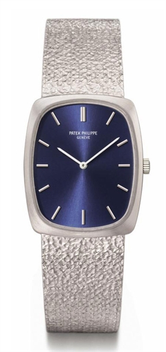 Patek Philippe. An 18K white gold tonneau-shaped wristwatch with bracelet