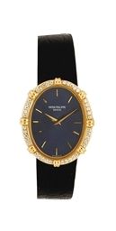 AN 18K YELLOW GOLD AND DIAMOND-SET OVAL WRISTWATCH, BY PATEK PHILIPPE