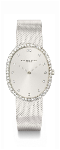 Audemars Piguet. A fine and slim 18K white gold and diamond-set oval wristwatch with bracelet and box