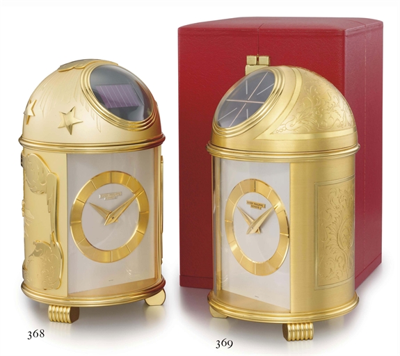 Patek Philippe. A fine and very rare gilt brass solar-powered dome table clock with original box