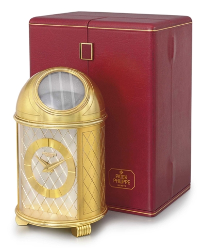 PATEK PHILIPPE. A FINE GILT BRASS SOLAR-POWERED DOMED TABLE CLOCK WITH ORIGINAL FITTED PRESENTATION BOX