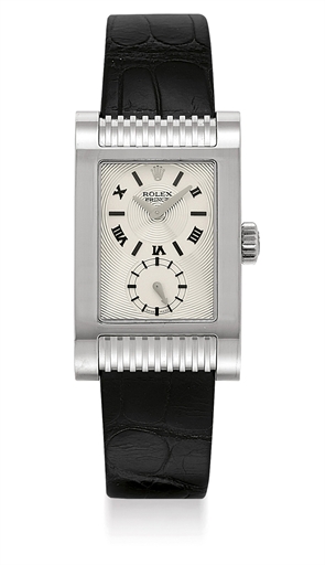 ROLEX. AN 18K WHITE GOLD RECTANGULAR CURVED WRISTWATCH
