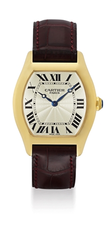 CARTIER. A FINE 18K GOLD TONNEAU-SHAPED WRISTWATCH