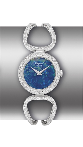 CHOPARD. A LADY'S 18K WHITE GOLD AND DIAMOND-SET BANGLE-WATCH WITH OPAL DIAL