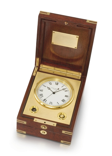 Patek Philippe. A gilt electronic marine chronometer with jumping centre seconds and original mahogany box
