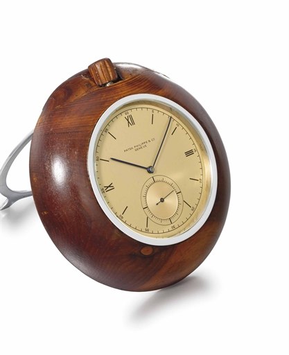 Patek Philippe. A rare and unusual stainless steel and wooden keyless lever desk timepiece