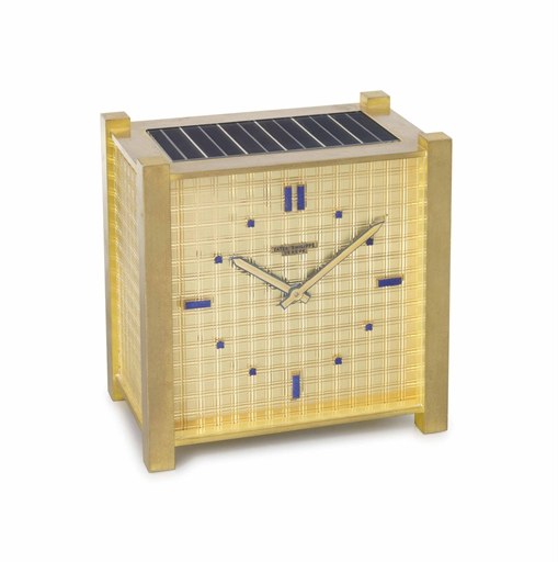 Patek Philippe. An unusual gilt brass and lapis lazuli square solar-powered desk clock with textured dial, sides and back panels