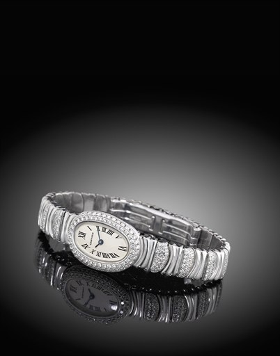 CARTIER. A LADY'S FINE 18K WHITE GOLD AND DIAMOND-SET OVAL BRACELET WATCH