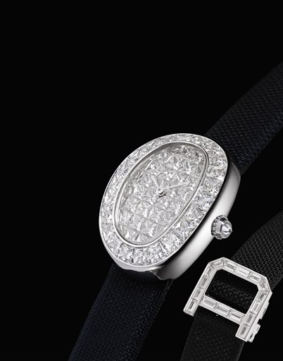 CARTIER. A LADY'S FINE AND RARE 18K WHITE GOLD AND DIAMOND-SET OVAL WRISTWATCH