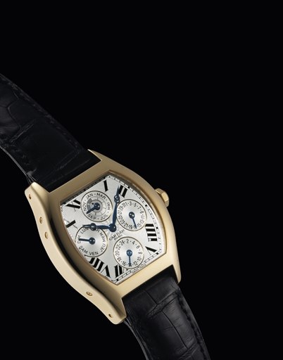 CARTIER. A FINE AND RARE 18K GOLD TONNEAU-SHAPED PERPETUAL CALENDAR DUAL TIME WRISTWATCH WITH LEAP YEAR INDICATION