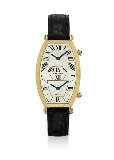 CARTIER. AN 18K GOLD TONNEAU-SHAPED CURVED DUAL TIME WRISTWATCH