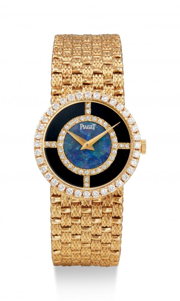 PIAGET | REFERENCE 9706, D 23 A YELLOW GOLD AND DIAMOND-SET BRACELET WATCH WITH OPAL AND ONYX DIAL, CIRCA 1990