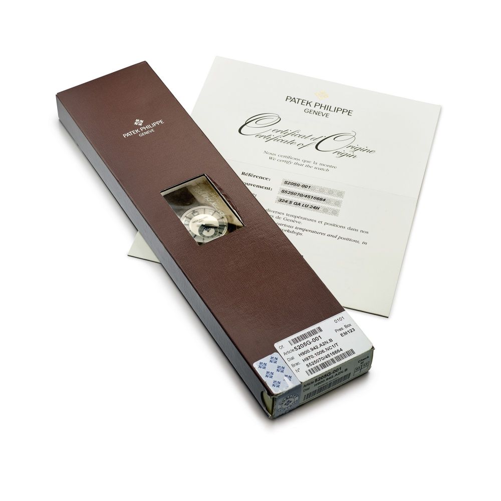 Patek Philippe | Reference 5205, A white gold annual calendar wristwatch with moon phases and 24 hours indication in double factory seal, Circa 2010 | 百達翡麗 | 型號5205 白金年曆腕錶，備月相及24小時顯示，原廠未開封，約2010年製