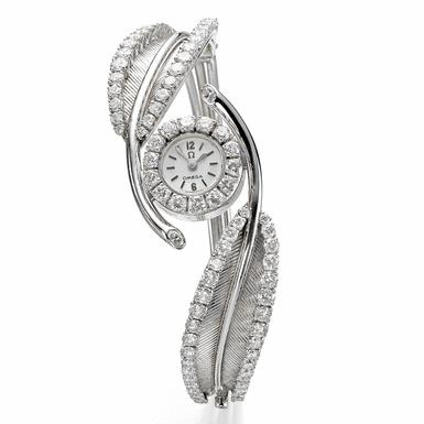 OMEGA - A LADY'S WHITE GOLD AND DIAMOND-SET BACK-WOUND BANGLE WATCH CIRCA 1965