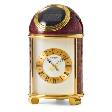 PATEK PHILIPPE - A FINE AND UNIQUE GILT BRASS SOLAR POWERED TABLE CLOCK WITH CLOISONN