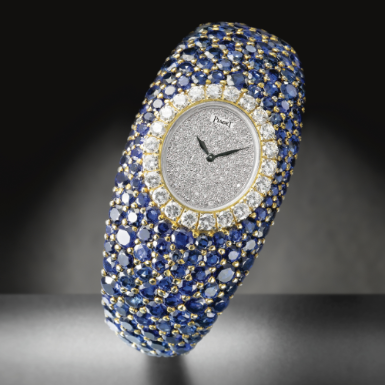 PIAGET - A LADY'S EXCEPTIONALLY FINE AND RARE 18K YELLOW GOLD SAPPHIRE AND DIAMOND-SET CUFF WATCH 1977 REF 7359