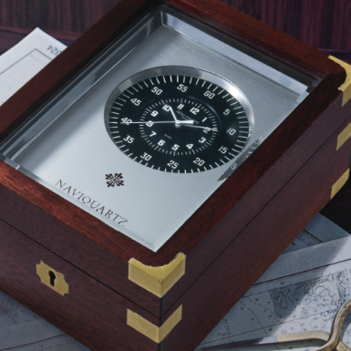 Property of an East Coast Gentleman - PATEK PHILIPPE - A RECTANGULAR CENTER SECONDS QUARTZ TIMEPIECE IN A BRASS BOUND MAHOGANY CASE 1982 REF E 1202 NAVIQUARTZ NO 1804016