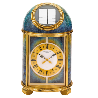 PATEK PHILIPPE - A FINE AND UNIQUE GILT-BRASS SOLAR-POWERED DESK TIMEPIECE WITH CLOISONN
