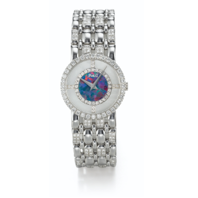 PIAGET - A LADY'S WHITE GOLD AND DIAMOND-SET BRACELET WATCH WITH OPAL AND MOTHER-OF-PEARL DIAL CIRCA 1985