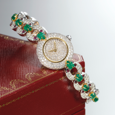 CARTIER - A LADY'S FINE WHITE GOLD, EMERALD, RUBY AND DIAMOND-SET BRACELET WATCH CIRCA 1990