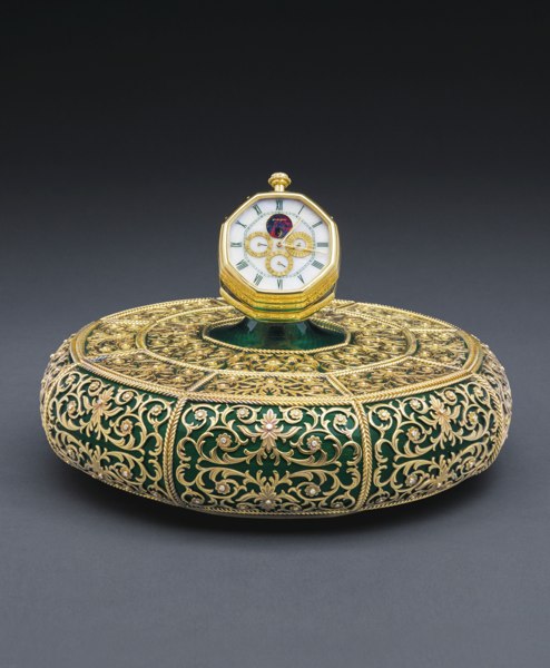 Gerald Genta "The Auspicious Octagonal Centerpiece" AN EXTRAORDINARY YELLOW GOLD, DIAMOND, WHITE OPALESCENT STONE, OPAL AND TRANSLUCENT GREEN ENAMEL TABLE CENTERPIECE OF EXHIBITION QUALITY, SET WITH A MINUTE REPEATING PERPETUAL CALENDAR CLOCK CIRCA 1990 R