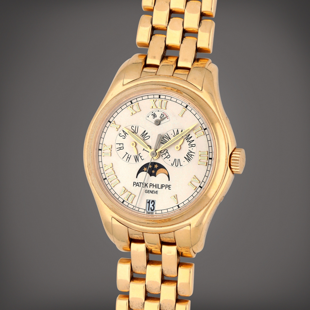 Reference 5036/1J-001 | A yellow gold annual calendar wristwatch with moon phase, power reserve indication and bracelet | Circa 2002