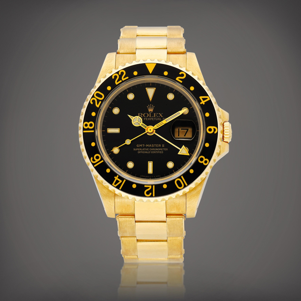 Rolex  GMT-Master II, Reference 16718 A yellow gold dual time wristwatch with date and bracelet, Circa 1990 