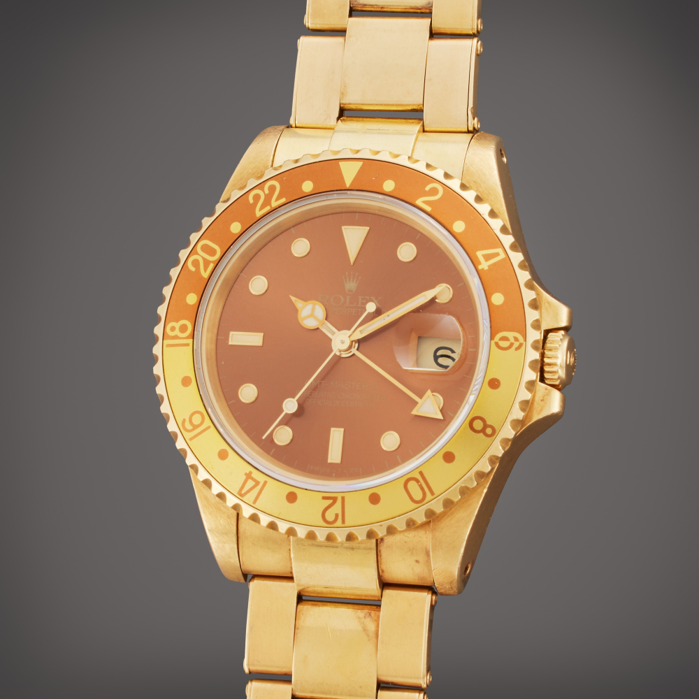 Rolex Reference 16718 GMT-Master II 'Root Beer' | A yellow gold automatic dual time wristwatch with date and bracelet, Circa 1991