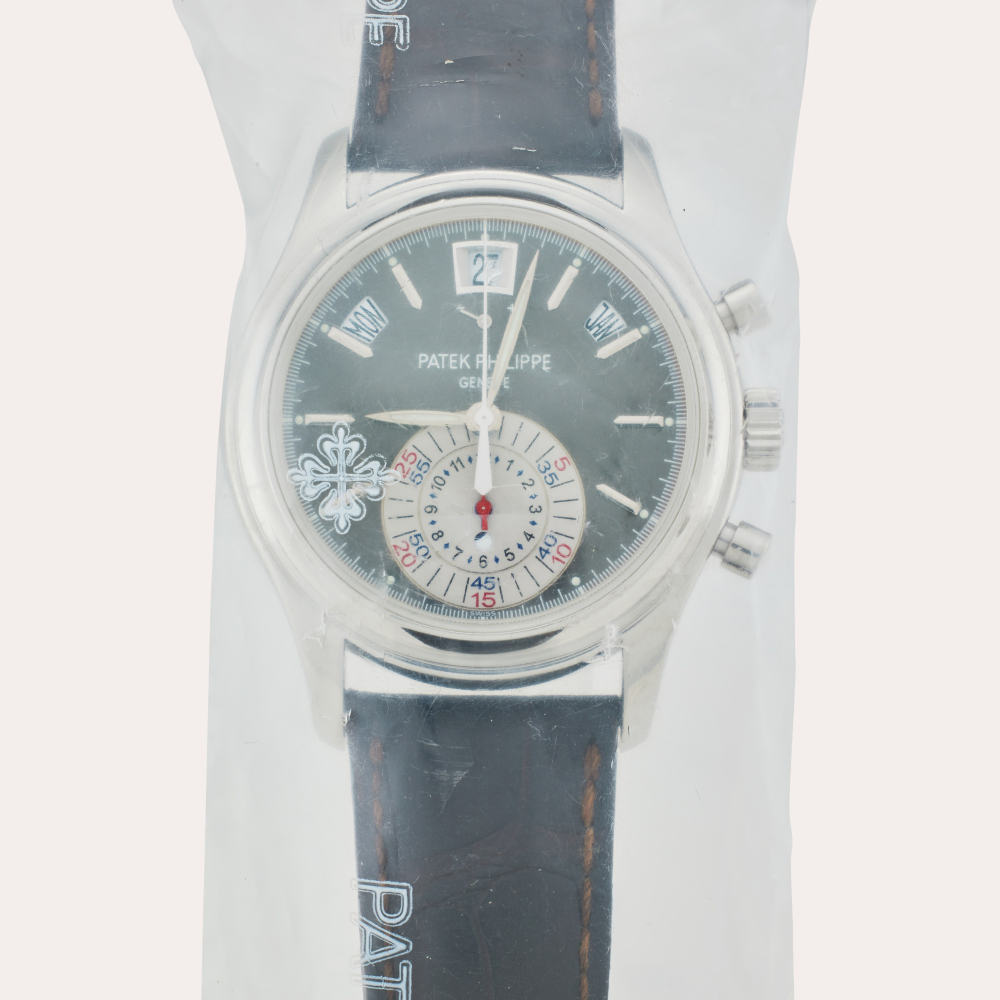 Patek Philippe Reference 5960P-001 | Retailed by Tiffany & Co.: A platinum annual calendar flyback chronograph wristwatch with power reserve and day/night indication, Service Sealed, Circa 2013