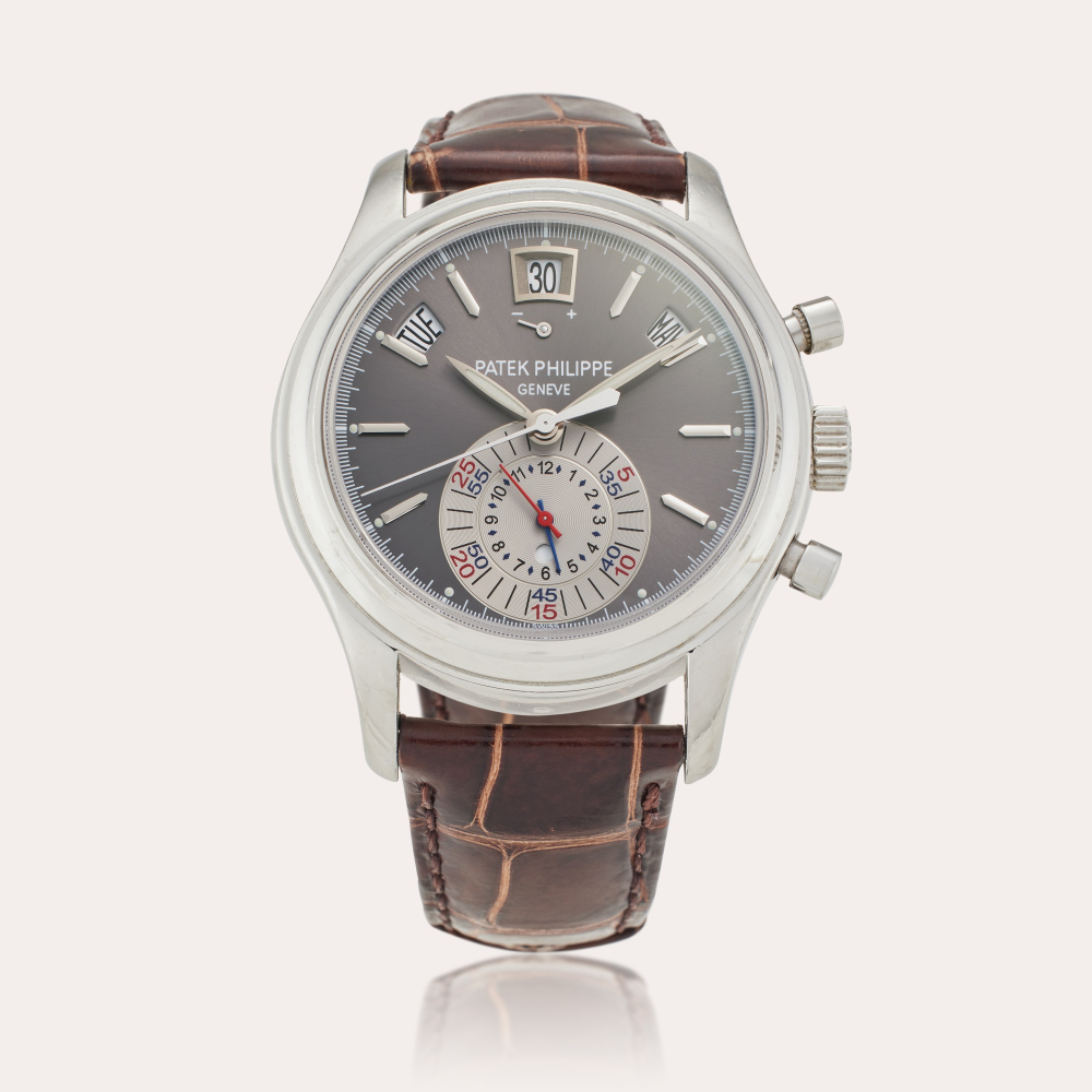 Patek Philippe Reference 5960P-001 | Retailed by Tiffany & Co.: A platinum annual calendar flyback chronograph wristwatch with power reserve and day/night indication, Circa 2008