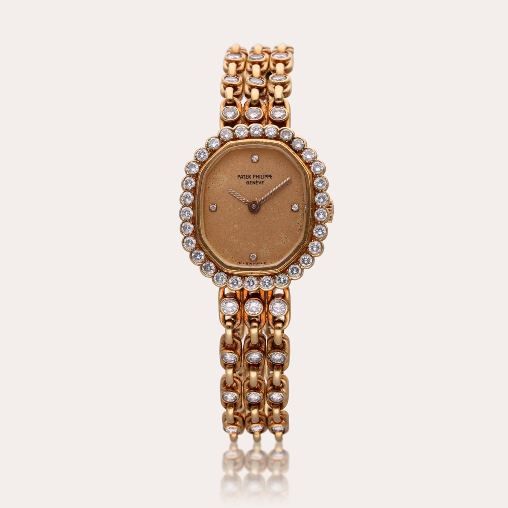 Patek Philippe Reference 4597/001 | A yellow gold and diamond-set bracelet watch, Circa 1985