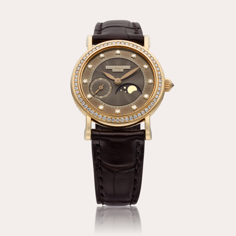 Patek Philippe Reference 4858 Calatrava | A yellow gold and diamond-set wristwatch with moon phases, Circa 2001