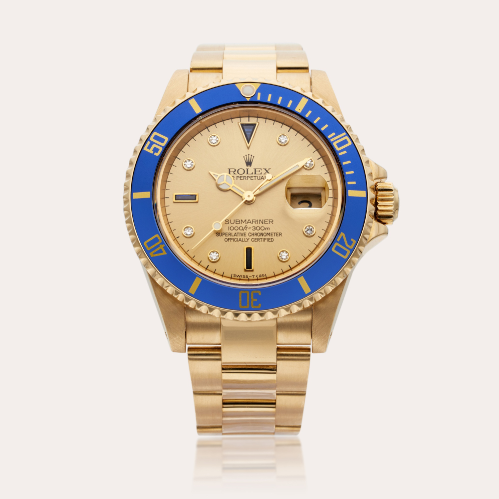 Rolex Reference 16618 Submariner | A yellow gold, diamond, and sapphire-set automatic wristwatch with date and bracelet, Circa 1993
